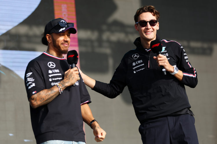 Lewis Hamilton of Great Britain and Mercedes and George Russell of Great Britain and Mercedes talk to the crowd on the fan stage prior to the Sprin...