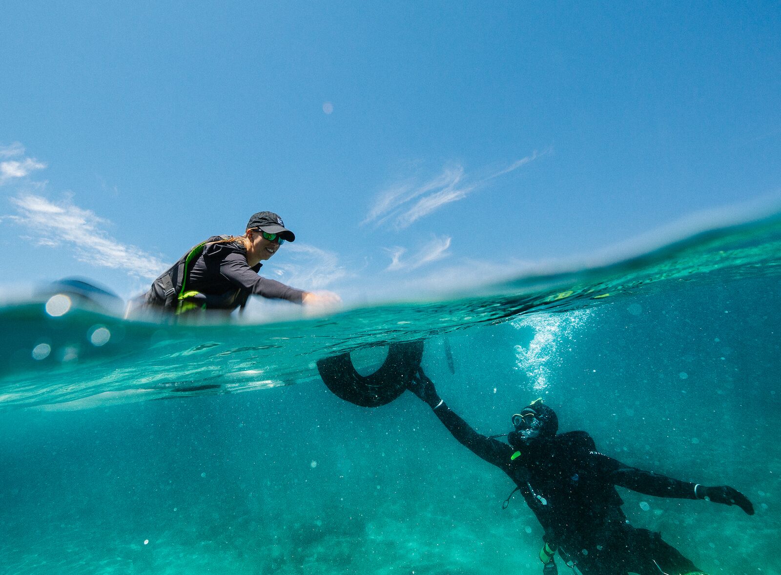 diver pulling tire out in a lake tahoe cleanup