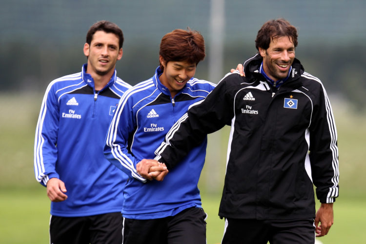 Gojko Kacar walks past Heung-Min Son and Ruud van Nistelrooy (L-R) during the pre-season training camp of Hamburger SV at the Aqua Dome hotel on Ju...