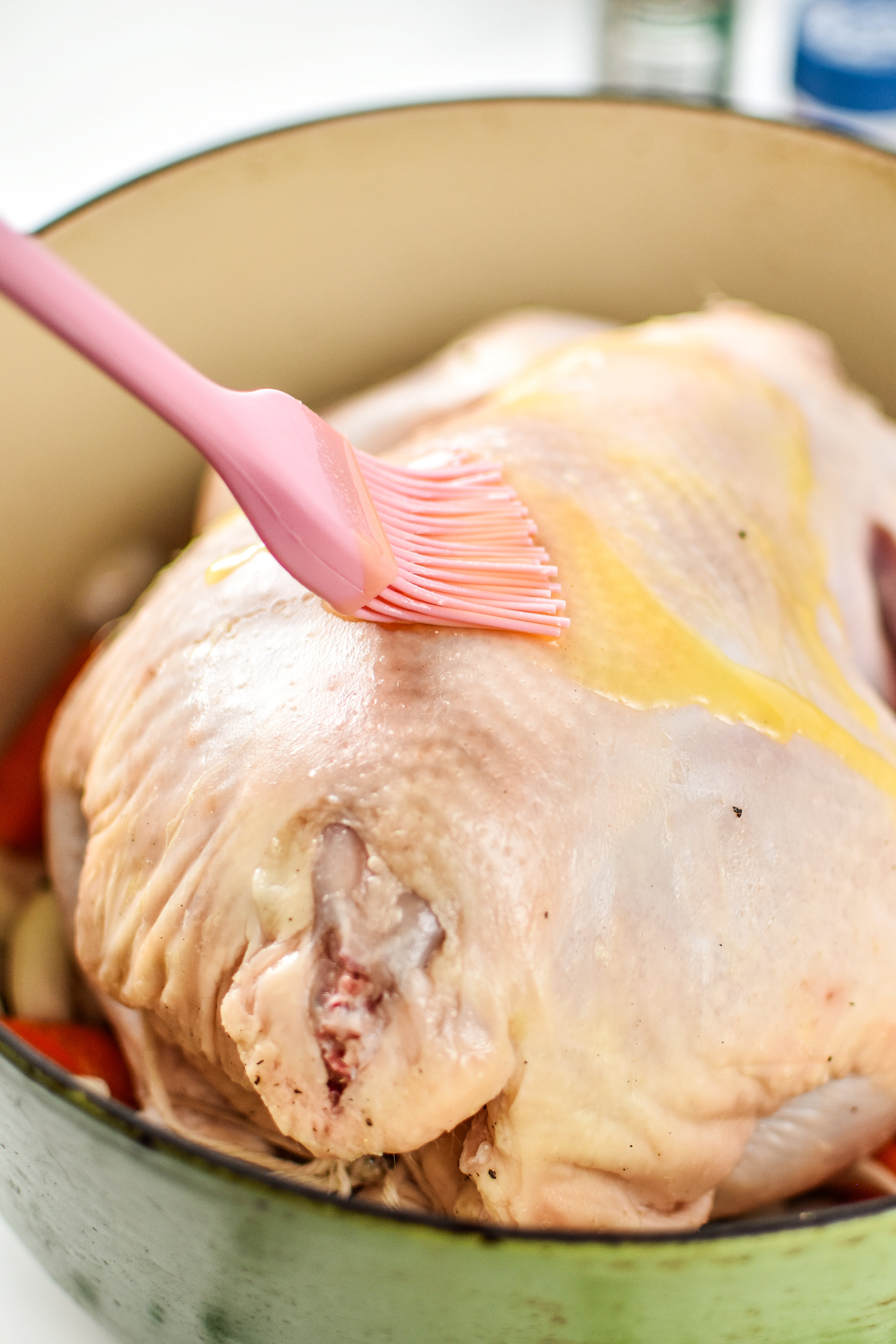 Brushing melted ghee on the chicken for the simple whole roast chicken.