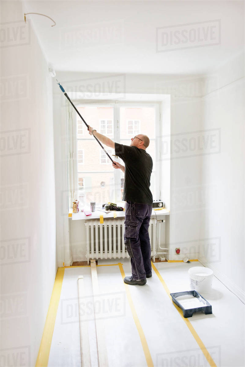 Man painting room - Stock Photo - Dissolve