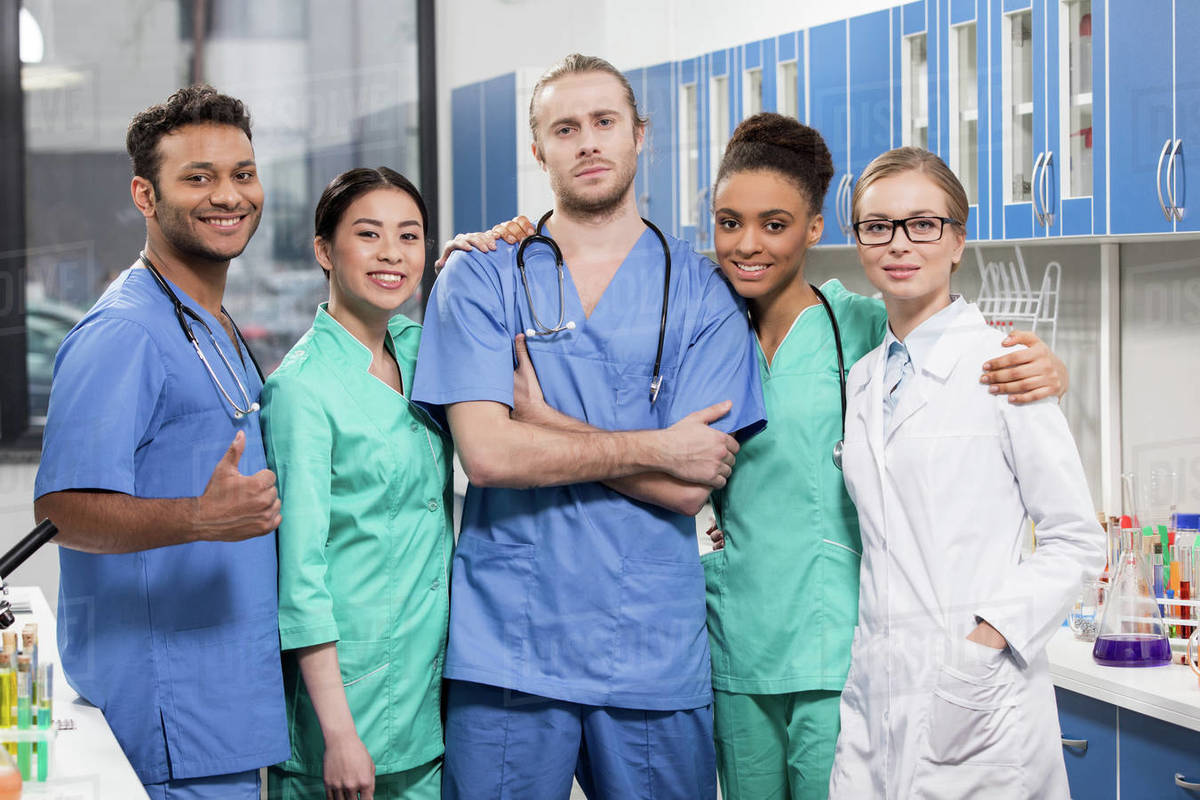 Portrait of group of medical workers in laboratory - Stock Photo - Dissolve