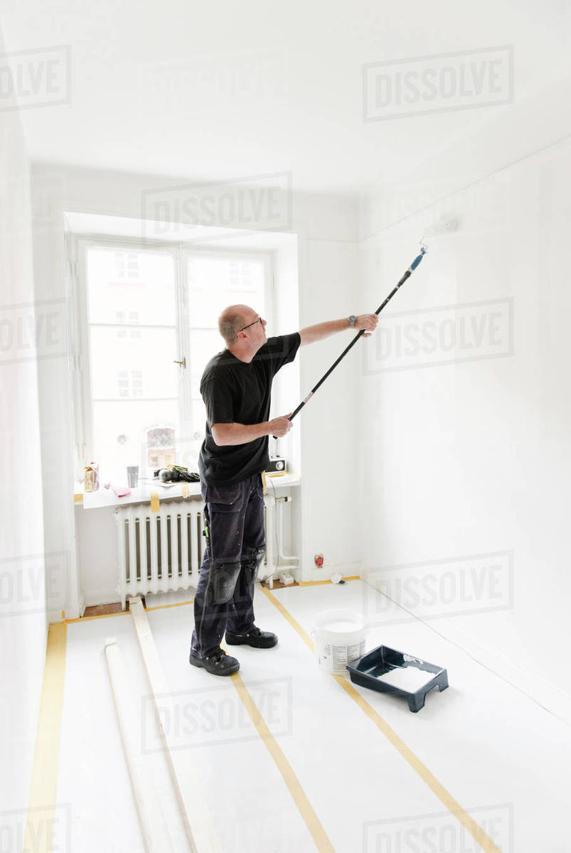 Man painting room - Stock Photo - Dissolve