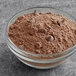 A bowl of Ghirardelli Ultimate Chocolate Cake mix powder with chocolate chips.