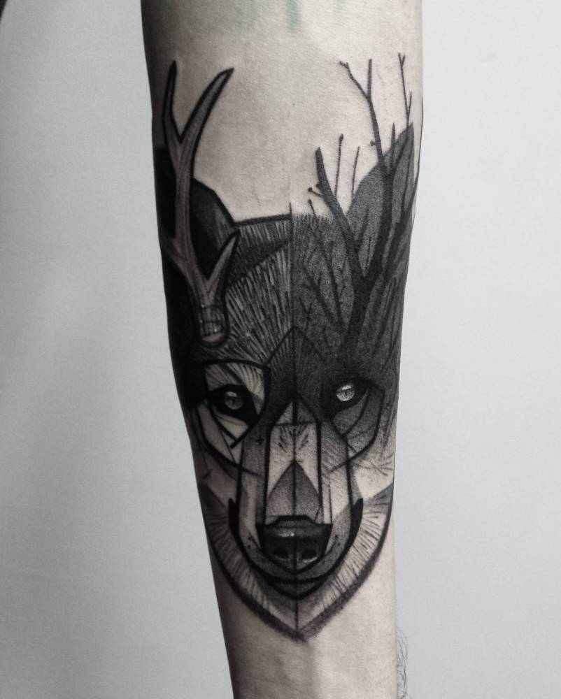 Sketch work wolf with antlers tattoo on the inner forearm.