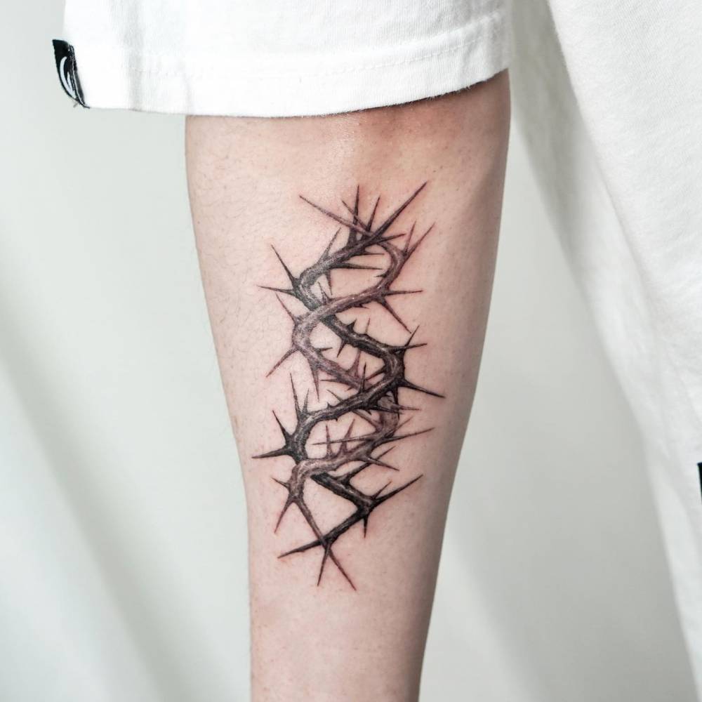 Thorns tattoo located on the forearm.