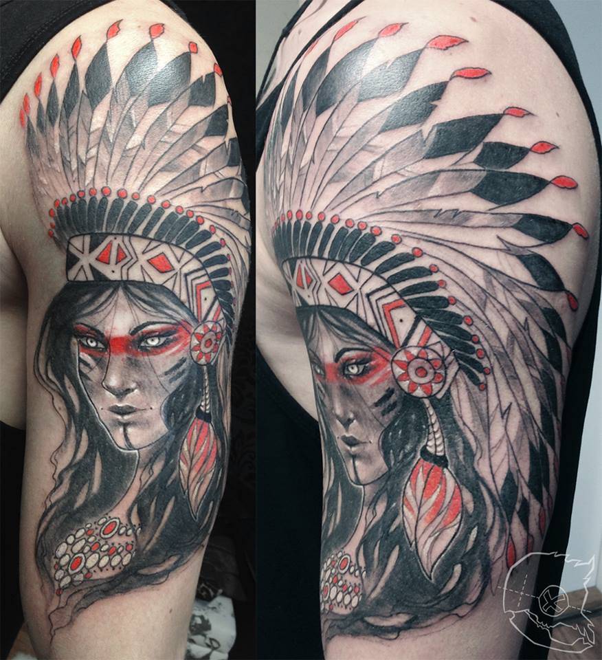 Female native American chief tattoo on the left upper arm.