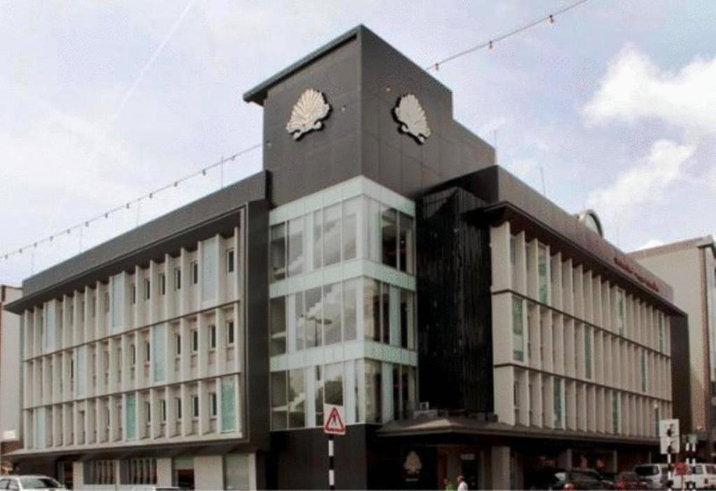 a black and white building with a clock tower at The Brunei Hotel in Bandar Seri Begawan