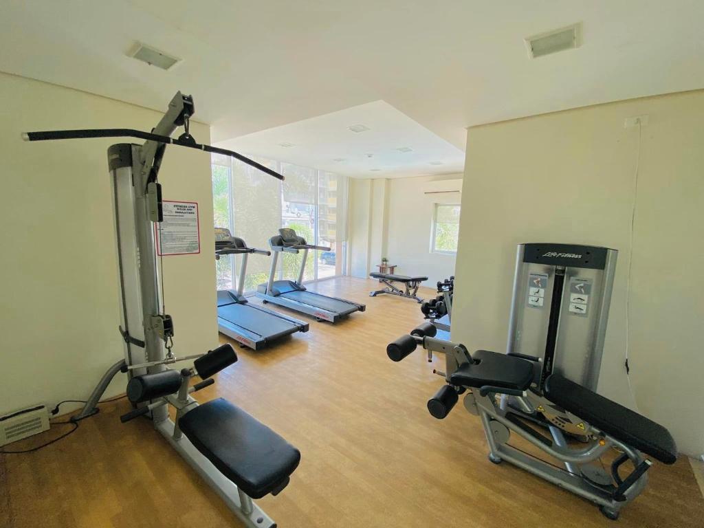 a gym with a row of treadmills and machines at 4138 Davao City 2bedroom unit 8 Spatial Maa by Filinvest in Davao City