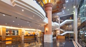 a lobby with a large column in a building at Bayview Hotel Georgetown Penang in George Town