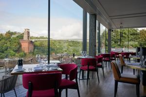 a restaurant with tables and chairs and a view of a bridge at Avon Gorge by Hotel du Vin in Bristol