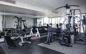 a gym with lots of treadmills and machines at Lagoon Beach Hotel Apartments in Cape Town