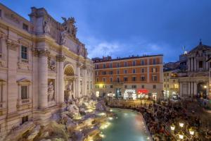 a group of people standing around a fountain in a city at Trevi Ab Aeterno - Amazing View of the Trevi Fountain in Rome