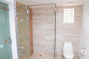 a bathroom with a shower and a toilet at Grand Decameron Cornwall Beach, A Trademark All-Inclusive Resort in Montego Bay