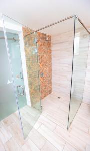 a shower with a glass door in a bathroom at Grand Decameron Cornwall Beach, A Trademark All-Inclusive Resort in Montego Bay