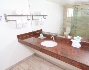 a bathroom with a sink and a mirror at Grand Decameron Cornwall Beach, A Trademark All-Inclusive Resort in Montego Bay