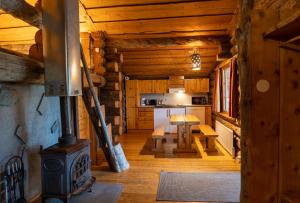 a living room with a stove in a log cabin at Arctic Log Cabins in Saariselka