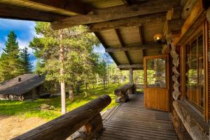 a porch of a log cabin with a door at Arctic Log Cabins in Saariselka