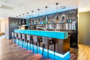 een bar met stoelen en een blauwe bar bij Motel One Edinburgh-Princes in Edinburgh