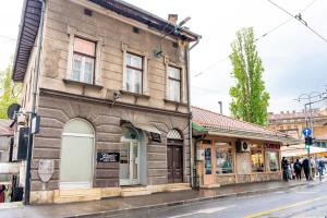 an old building on a street in a city at Bascarsija Guesthouse - Private Bath, TV & AirCon in Sarajevo