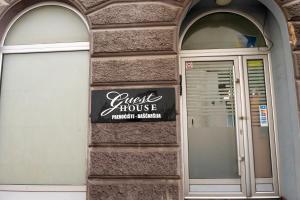 a sign on the side of a building at Bascarsija Guesthouse - Private Bath, TV & AirCon in Sarajevo