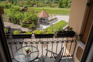 uma varanda com vista para um jardim e um gazebo em Relax House Soča em Bovec