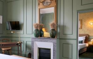 a living room with two vases on a fireplace at Hôtel Bristol Pau in Pau