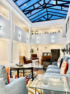 a living room with blue ceilings and couches at Hotel Aluxor SFO, Sapphire Boutique Collection in San Bruno