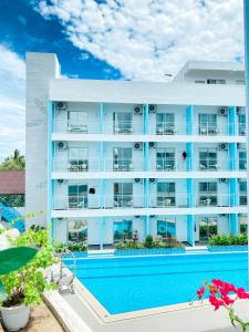 a large apartment building with a swimming pool at Bohol Dolphin Bay Resort in Panglao Island