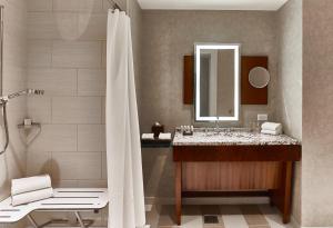 a bathroom with a sink and a shower with a mirror at Renaissance Atlanta Midtown Hotel in Atlanta