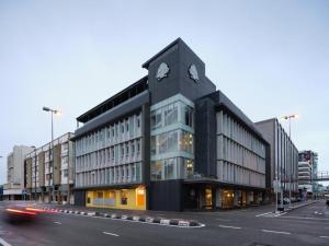 a building with a clock tower on top of it at The Brunei Hotel in Bandar Seri Begawan