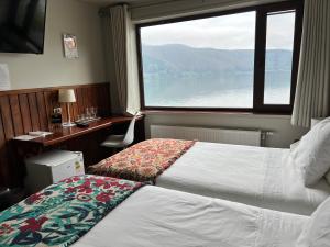 a hotel room with a bed and a window at Hotel Boutique Cutipay in Valdivia