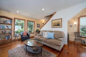 a living room with a couch and a table at Siletz Bay Beach House in Lincoln City