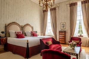 a bedroom with a large bed and two chairs at Valverde Sintra Palácio de Seteais - The Leading Hotels of the World in Sintra