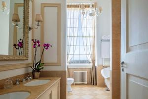 a bathroom with a sink and a toilet and a mirror at Valverde Sintra Palácio de Seteais - The Leading Hotels of the World in Sintra