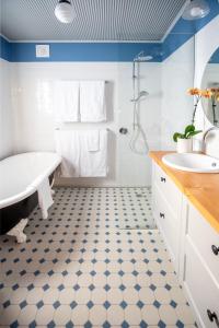 a bathroom with a tub and a sink at Willunga Gallery Cabins in Willunga