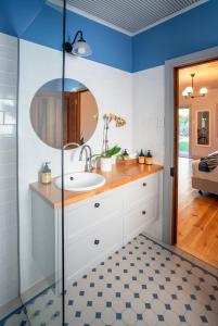 a bathroom with a sink and a mirror at Willunga Gallery Cabins in Willunga