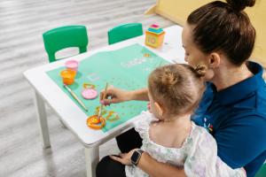 a woman and a little girl playing with a table at Paradise Resort Gold Coast in Gold Coast