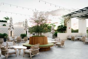 a patio with tables and chairs and a fountain at THesis Hotel Miami Coral Gables, Curio Collection by Hilton in Miami