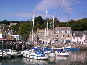 a group of boats docked in a harbor with people at Trevarrian Lodge in Newquay