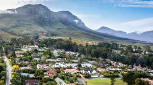 an aerial view of a small town in front of mountains at Villa Helderberg in Somerset West