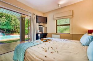 a bedroom with a bed with confetti on it at Villa Helderberg in Somerset West