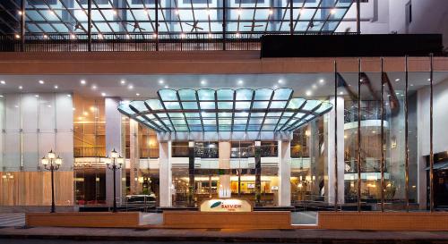 a large building with a glass ceiling in front of it at Bayview Hotel Georgetown Penang in George Town