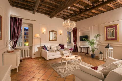 a living room with a couch and a table at Trevi Ab Aeterno - Amazing View of the Trevi Fountain in Rome