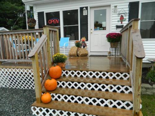 a wooden staircase with oranges on it in front of a house at Belle Isle Motel in Bar Harbor