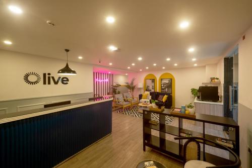 a living room with a bar in a room at Olive Zip Richmond Circle by Embassy Group in Bangalore