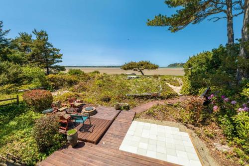 a wooden deck with a view of the beach at Siletz Bay Beach House in Lincoln City