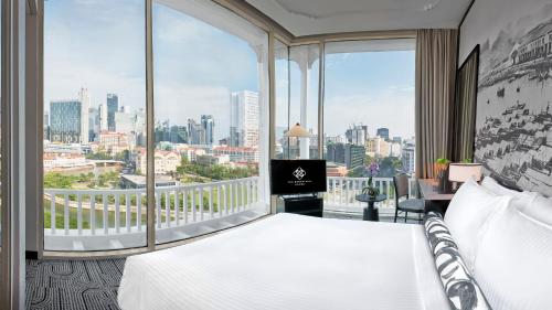 a hotel room with a bed and a large window at The Robertson House managed by The Ascott Limited in Singapore