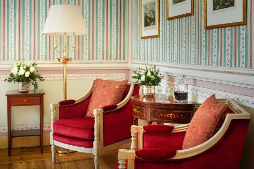 a room with two chairs and a table and a lamp at Valverde Sintra Palácio de Seteais - The Leading Hotels of the World in Sintra