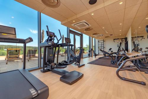 een fitnessruimte met verschillende loopbanden en crosstrainers bij Hotel GLAR Conference & SPA in Wisełka